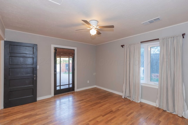 spare room featuring ceiling fan, wood-type flooring, and a textured ceiling