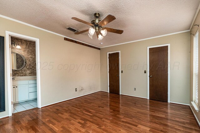 6700 Deer Park Dr, Amarillo, TX 79124 - unfurnished bedroom featuring wood finished floors, a textured ceiling, ornamental molding, connected bathroom, and ceiling fan