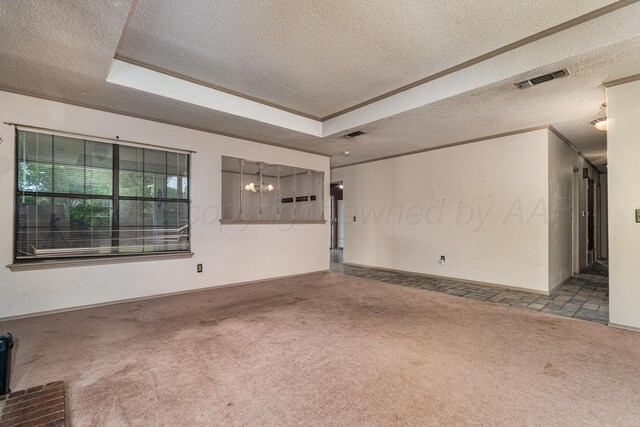 6700 Deer Park Dr, Amarillo, TX 79124 - carpeted empty room with a textured ceiling and a raised ceiling