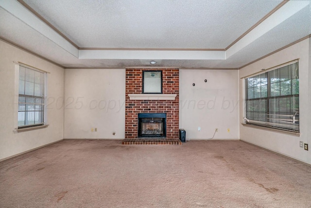 6700 Deer Park Dr, Amarillo, TX 79124 - unfurnished living room featuring a raised ceiling, ornamental molding, carpet floors, a textured ceiling, and a fireplace
