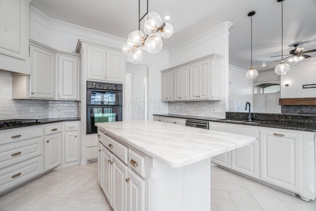 kitchen featuring backsplash, crown molding, a sink, and black appliances