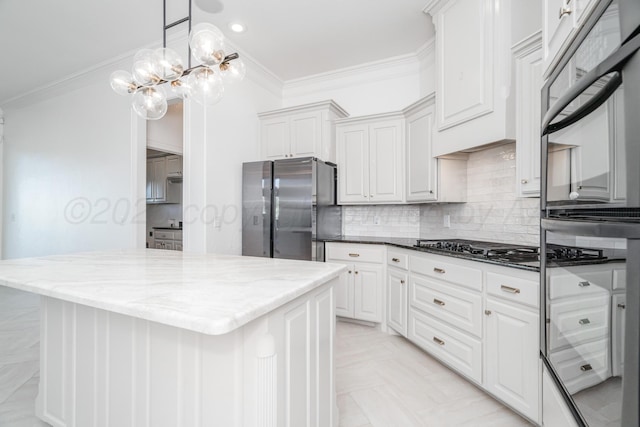 kitchen featuring ornamental molding, an inviting chandelier, gas cooktop, and freestanding refrigerator