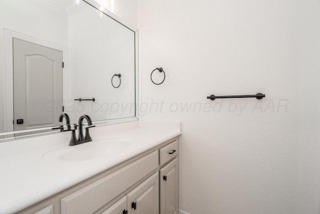 bathroom featuring ornamental molding and vanity