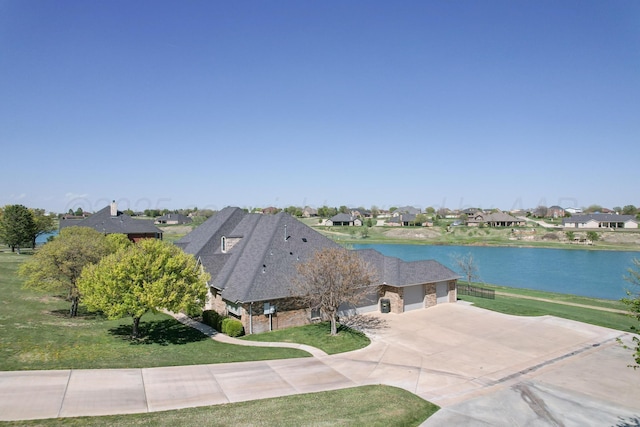 bird's eye view featuring a residential view and a water view
