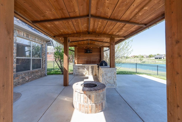 view of patio / terrace with a fire pit and fence