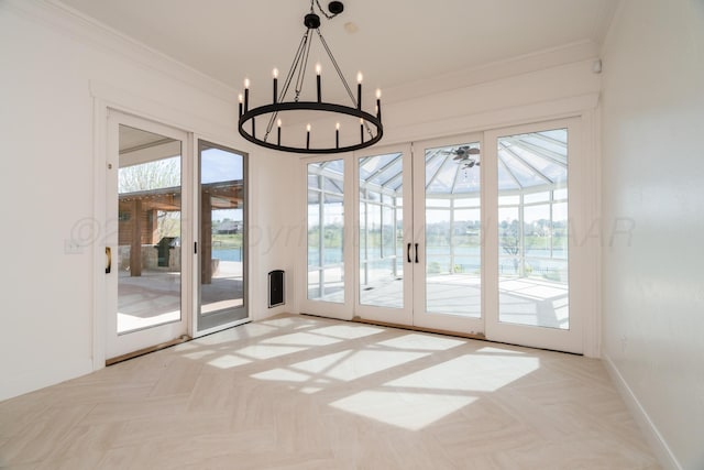 entryway featuring baseboards, crown molding, and ceiling fan with notable chandelier
