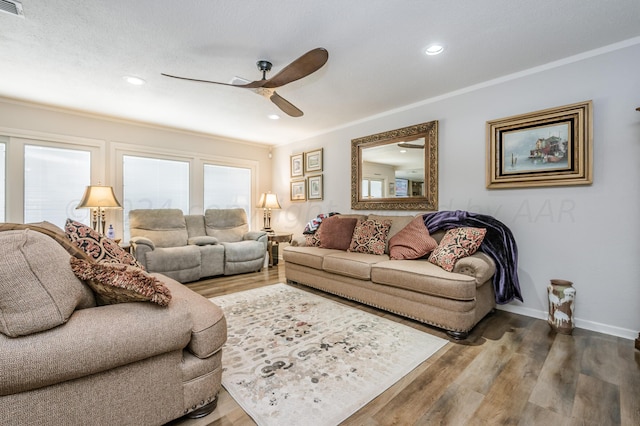 living room with crown molding, a textured ceiling, hardwood / wood-style flooring, and ceiling fan