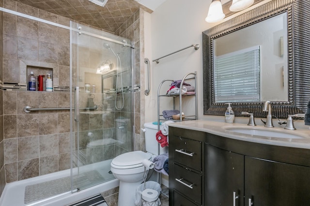 bathroom with toilet, tile patterned floors, vanity, and a shower with door