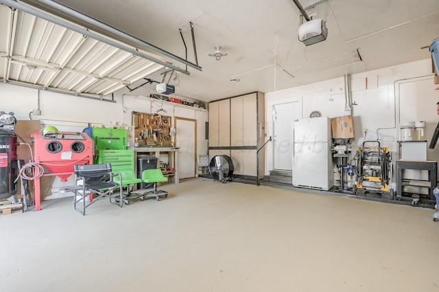 garage featuring a garage door opener and white refrigerator