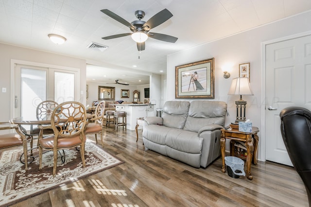 living room with hardwood / wood-style floors and ceiling fan