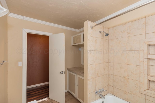 bathroom featuring a textured ceiling, baseboards, bathtub / shower combination, and crown molding