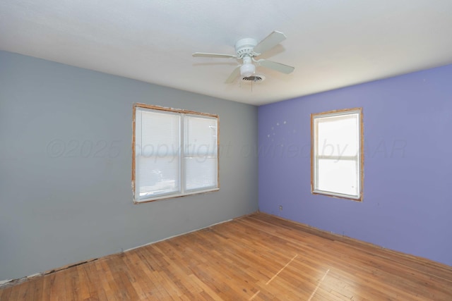 unfurnished room with light wood-style floors and a ceiling fan