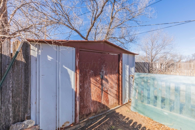 view of shed with fence