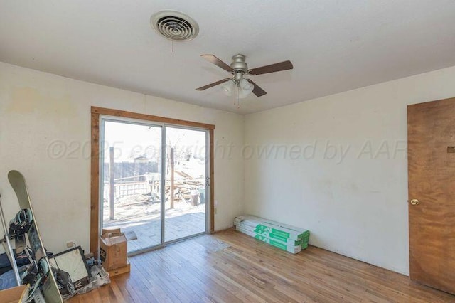 unfurnished room with light wood-style floors, ceiling fan, and visible vents