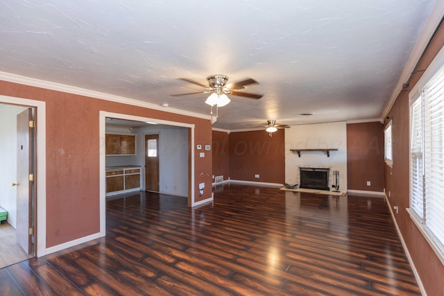 unfurnished living room featuring baseboards, a fireplace, wood finished floors, and crown molding