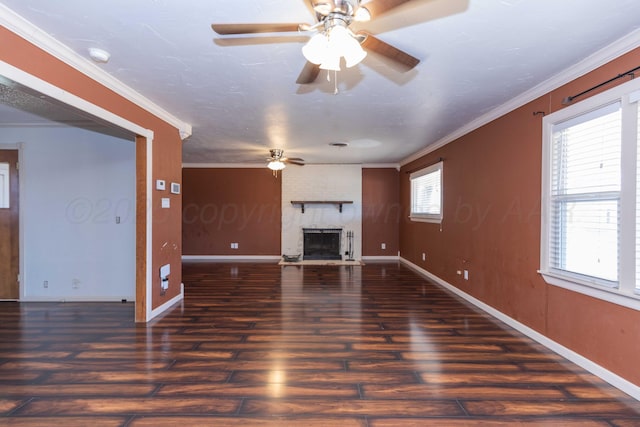 unfurnished living room with ceiling fan, a fireplace, crown molding, and wood finished floors