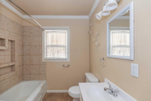 bathroom featuring baseboards, a sink, toilet, and crown molding