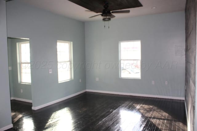 unfurnished room with dark wood-style floors, ceiling fan, and baseboards