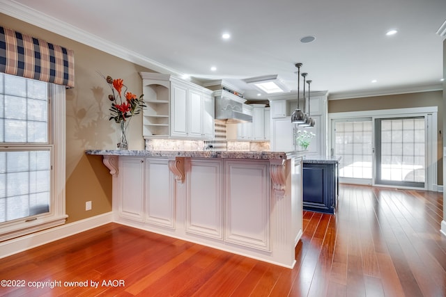 2223 S Ong St, Amarillo, TX 79109 - kitchen with open shelves, a peninsula, plenty of natural light, white cabinets, and ornamental molding