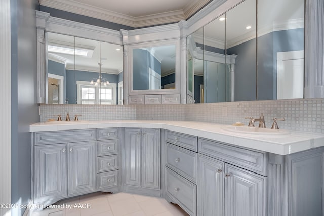 2223 S Ong St, Amarillo, TX 79109 - bathroom with double vanity, decorative backsplash, crown molding, a chandelier, and tile patterned flooring