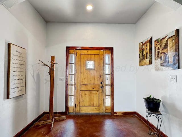 entryway with recessed lighting, finished concrete flooring, and baseboards