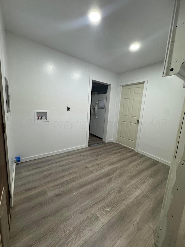 interior space with hookup for a washing machine and dark hardwood / wood-style flooring