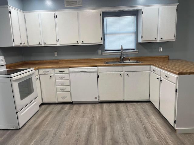 kitchen featuring white cabinetry, white appliances, and sink