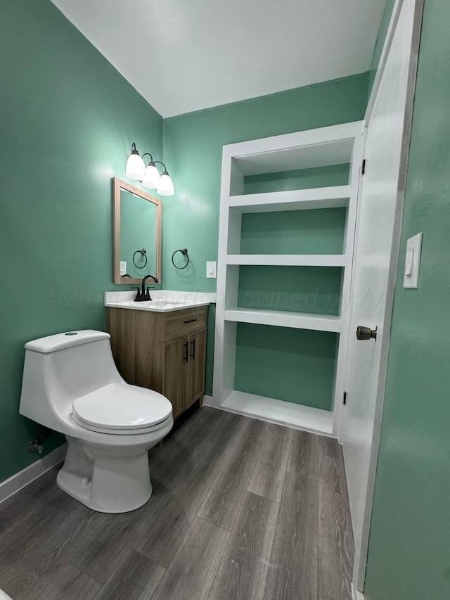 bathroom featuring hardwood / wood-style flooring, vanity, and toilet