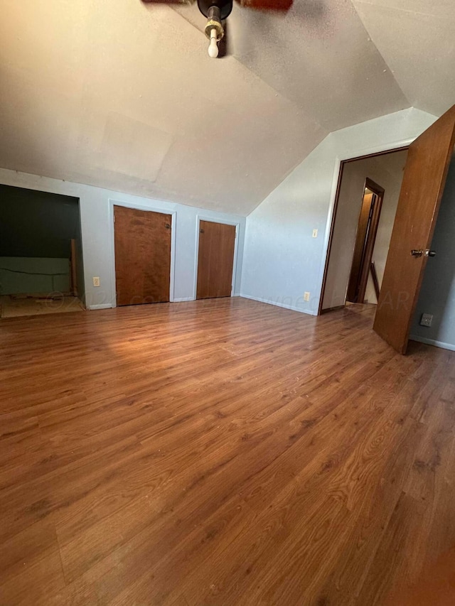 bonus room featuring lofted ceiling, hardwood / wood-style flooring, and ceiling fan