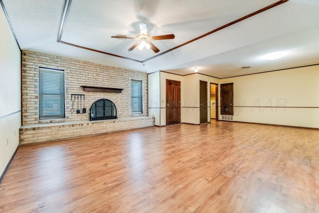 unfurnished living room featuring a textured ceiling, a ceiling fan, and wood finished floors