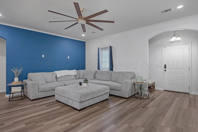 6809 Fanchun St, Amarillo, TX 79119 - living room featuring arched walkways, ceiling fan, crown molding, wood finished floors, and recessed lighting