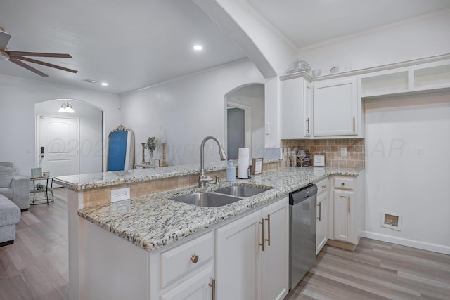6809 Fanchun St, Amarillo, TX 79119 - kitchen with arched walkways, dishwasher, ceiling fan, a peninsula, and light stone counters