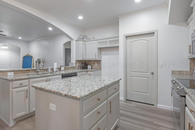6809 Fanchun St, Amarillo, TX 79119 - kitchen featuring stainless steel appliances, arched walkways, tasteful backsplash, a center island, and recessed lighting
