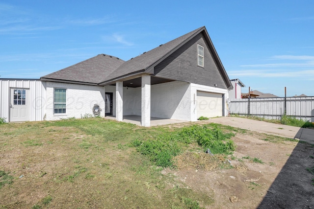 6809 Fanchun St, Amarillo, TX 79119 - back of house with a garage, brick siding, concrete driveway, and roof with shingles