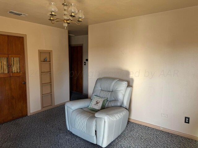 sitting room featuring carpet flooring and a chandelier