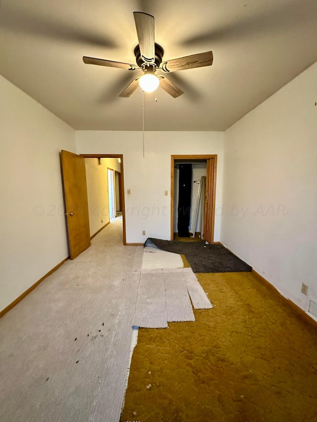 carpeted empty room with ceiling fan