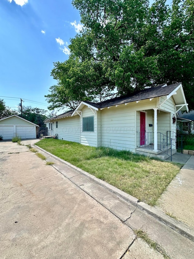 single story home with a garage and an outbuilding