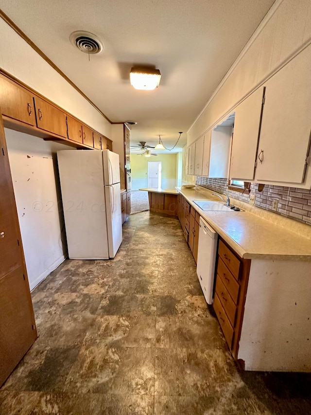 kitchen featuring white appliances, decorative backsplash, sink, kitchen peninsula, and ceiling fan