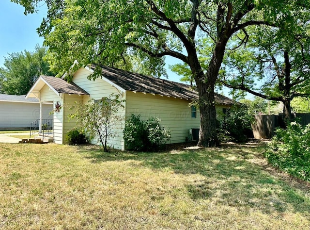 view of side of property featuring a yard