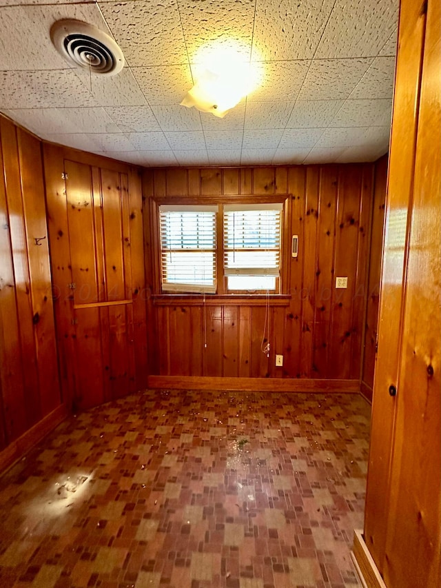 empty room featuring wood walls