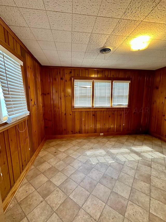 empty room featuring wooden walls