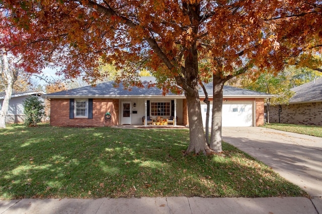 single story home with a front lawn, a porch, and a garage