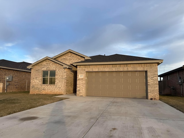 single story home featuring a garage, concrete driveway, and brick siding