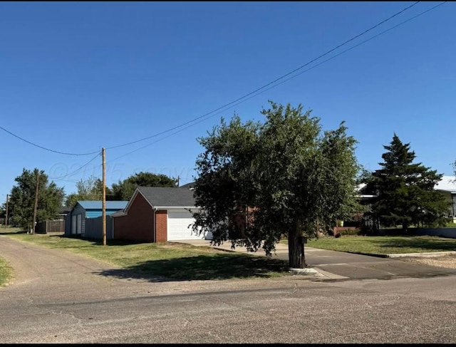 view of front of property featuring a garage and a front lawn