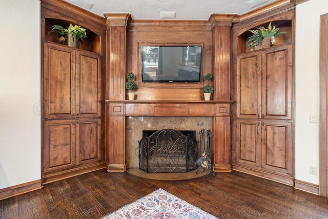 unfurnished living room featuring a fireplace and dark hardwood / wood-style flooring