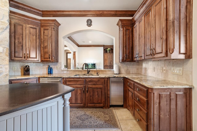 kitchen featuring sink, crown molding, backsplash, light stone counters, and stainless steel dishwasher