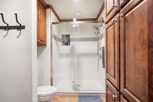 bathroom with tile patterned flooring, a shower with shower door, and toilet