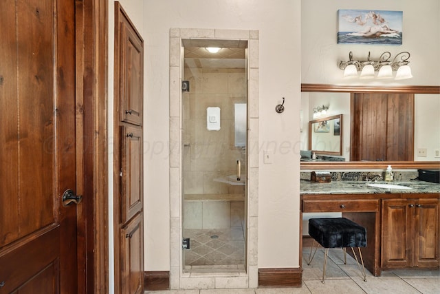 bathroom featuring vanity, tile patterned flooring, and a shower with door