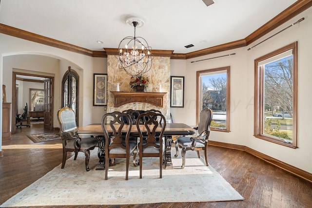 dining space with a notable chandelier, crown molding, and dark hardwood / wood-style floors