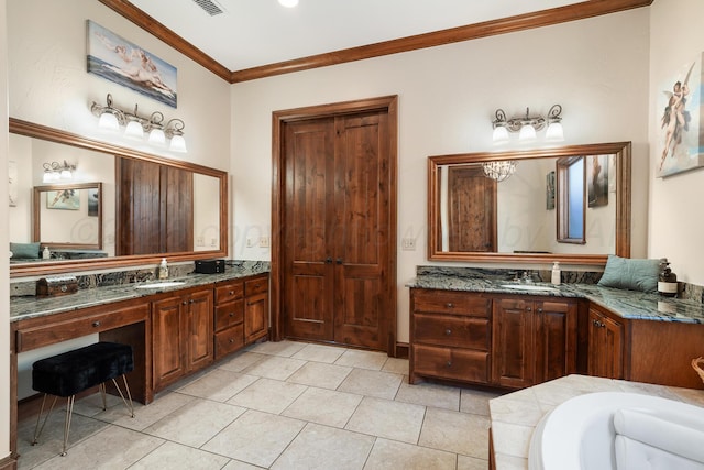 bathroom featuring tile patterned flooring, ornamental molding, a bathing tub, and vanity